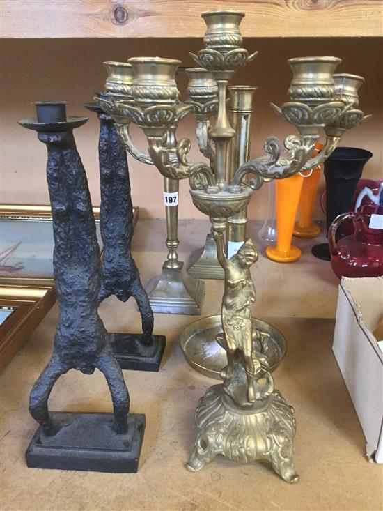 Pair of iron acrobat figure candlesticks, a five light candelabrum and three other candlesticks